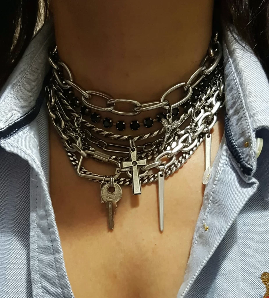 #GothicFashion #PunkJewelry
Massive silver seven-layer chunky choker necklace with cross, key, and spike charms on a dark background.